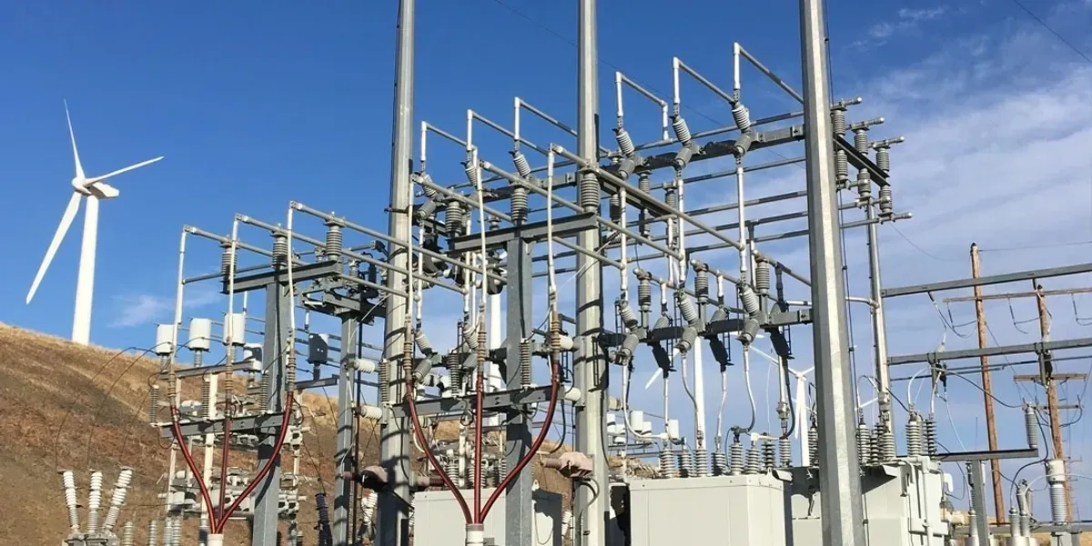 A power plant with many wires and poles.