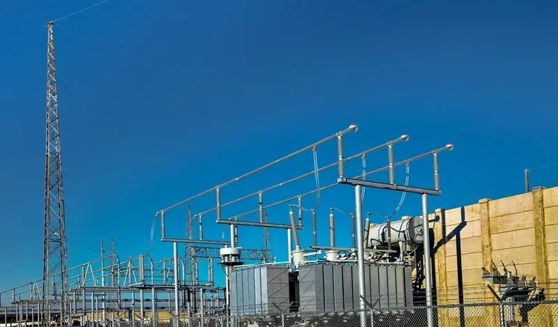 A power plant with many wires hanging from the sides.